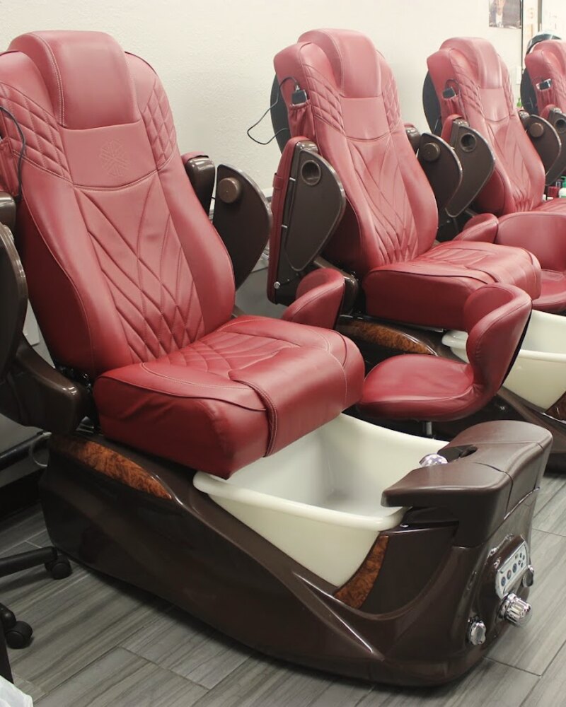 A burgundy leather pedicure chair with a white basin in the nail lounge at Kristin's Hair Design