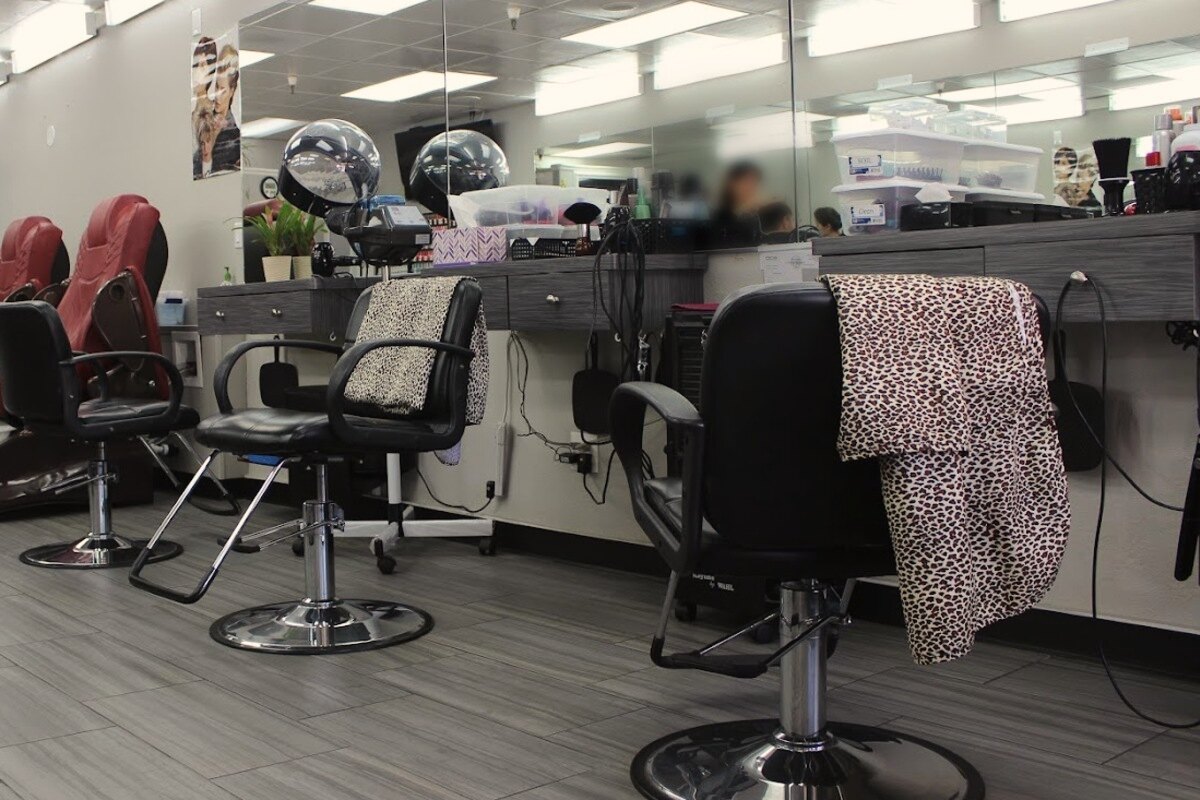 Hair-cutting stations at Kristin's Hair Design, with styling chairs facing the mirrored counter